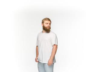 Closeup of young man's body in empty white t-shirt isolated on white background. Mock up for disign concept