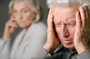 Fototapeta premium Senior man with headache holding
