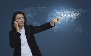 Caucasian business woman talking on her cell phone and pointing or touching touchscreen over gradient light blue background, Business communication concept