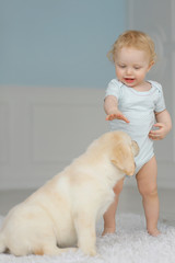 Little girl with labrador puppy