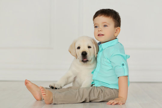 Boy with labrador puppy