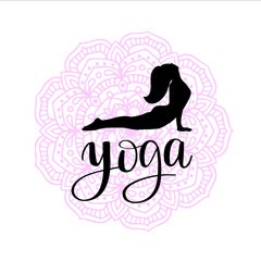 silhouette of woman making yoga exercise on colored mandala background