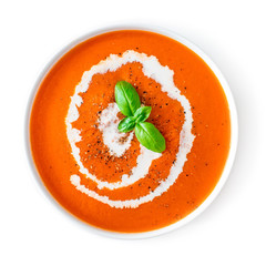 Tomato soup in a white bowl isolated on white background. Top view. Copy space. Traditional cold...