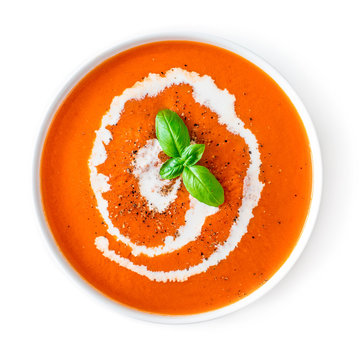 Tomato soup in a white bowl isolated on white background. Top view. Copy space. Traditional cold gazpacho soup. Spanish cusine.