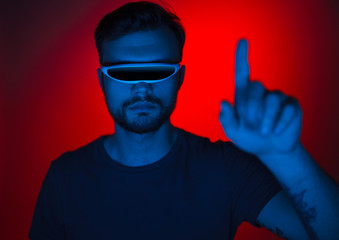 Man in futuristic glasses scrolling virtual information