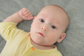 A newborn boy lies on a bed