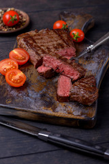 Closeup sliced beef steak and tomatos