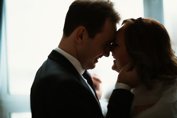 young bride and groom couple in a bright studio photo