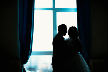 young bride and groom couple in a bright studio photo