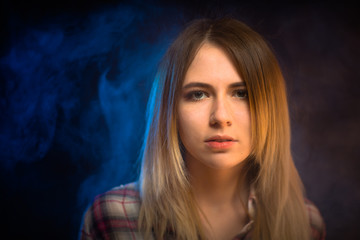 Fototapeta premium portrait smiling girl on blue background in studio