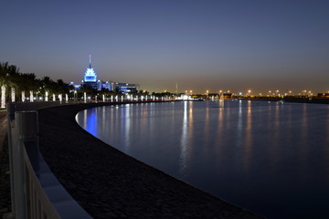 Dubai, United Arab Emirates - May 21, 2018: Dubai Silicon Oasis Headquarters Building with Lake view at night, Established in 2014 a free zone owned by the Government of Dubai.