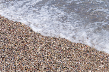 Pebble wave beach summer sea background close