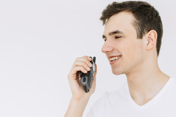 Young Man with portable radio Isolated on the White Background. Сlose-up.