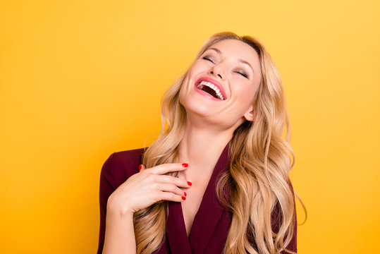 Portrait of positive cheerful sincerely woman laughing with close eyes wearing formalwear isolated on yellow background
