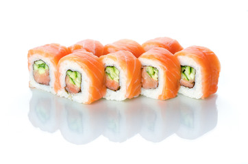 sushi rolls salmon cucumber and spice sauce on white background with reflection