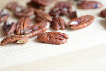 Pecan nuts on a wooden background close up