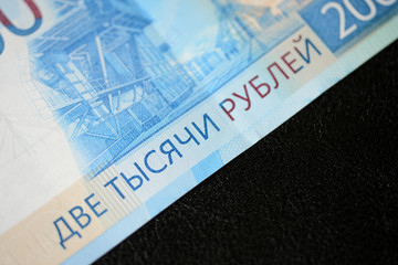 Russian banknote in two thousand rubles on a dark background close up