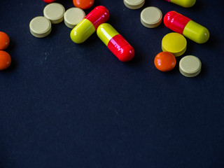 The pills are scattered on a black background. Tablets are scattered. Placebo.
