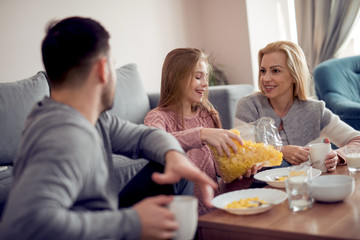Happy family having breakfast together at home