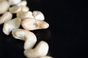 Cashew nuts on a dark background close up