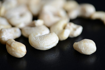 Cashew nuts on a dark background close up