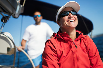 Attractive strong woman sailing with her boat