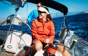Fotobehang Attractive strong woman sailing with her boat © NDABCREATIVITY