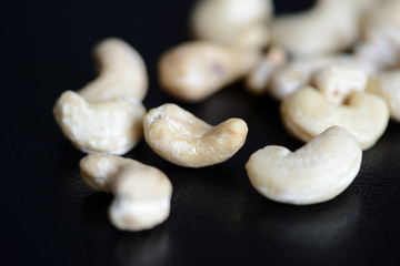 Cashew nuts on a dark background close up