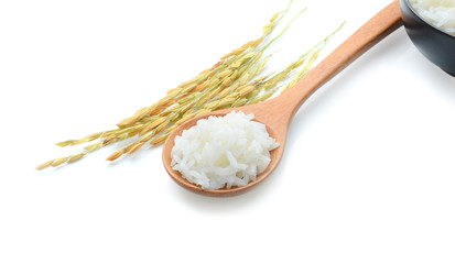 White rice on the wooden spoon on white