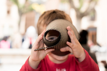 Child looking through a piece of paper
