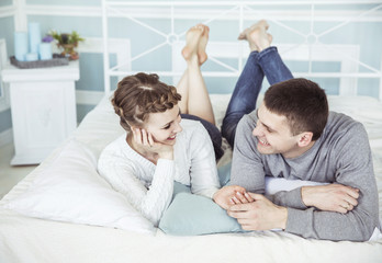 concept of family happiness:loving couple on the bed in the bedroom