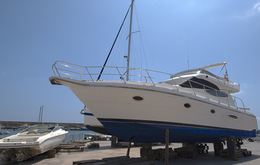 Fishing boat in the harbor to be repaired. Summer.