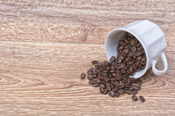 Coffee spill out of a white cup on table