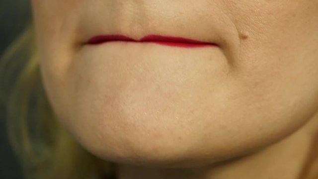 Extreme close up of sexy lip. Woman pursing her lips in a sexy seductive gesture. slow motion