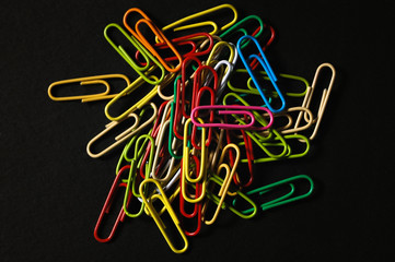 Paper clips multi-coloured on a dark  background