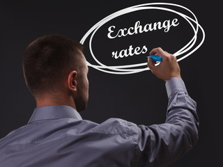 The concept of business, technology, the Internet and the network. Young businessman showing inscription: Exchange rates