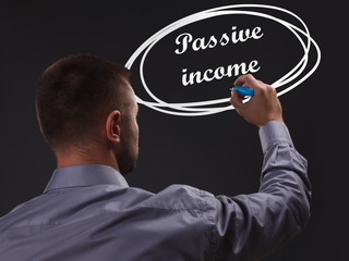 The concept of business, technology, the Internet and the network. Young businessman showing inscription: Passive income