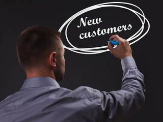 The concept of business, technology, the Internet and the network. Young businessman showing inscription: New customers