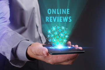 The concept of business, technology, the Internet and the network. A young entrepreneur working on a virtual screen of the future and sees the inscription: Online reviews