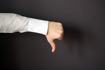 Young Woman's Hand Shows Thumbs Down Gesture