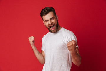 Excited young handsome man make winner gesture.