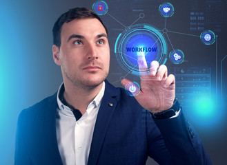 Business, Technology, Internet and network concept. Young businessman working on a virtual screen of the future and sees the inscription: Workflow