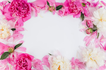 Floral frame wreath made of pink and white peonies flower buds. Flat lay, top view.