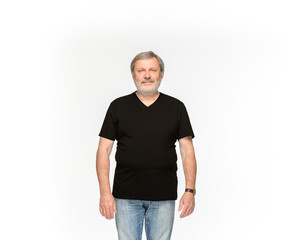 Fototapeta premium Closeup of senior man's body in empty black t-shirt isolated on white background. Mock up for disign concept