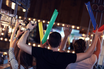 Group of friends watching soccer in pub