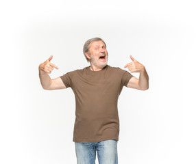 Closeup of senior man's body in empty brown t-shirt isolated on white background. Mock up for disign concept