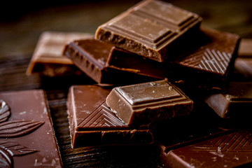 black chocolate close up on wooden background