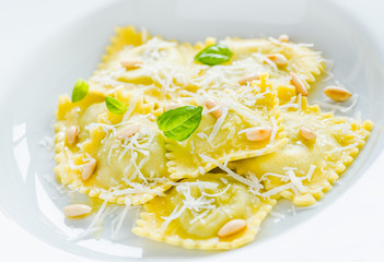 Ravioli with ricotta and spinach, Italian traditional pasta dish close up.