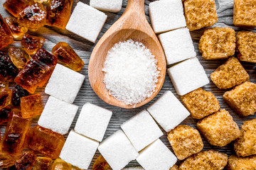 cooking sweets set with sugar in spoons on kitchen table backgro