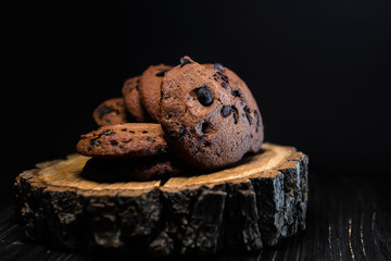 chocolate cookies with chocolate drops on wooden background